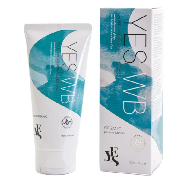 A 100ml tube of YES® WB Water-Based Lubricant by YES® is positioned beside its box packaging. The tube and box feature a white and teal design with product information and logos indicating it is pH balanced, certified organic, and provides long-lasting hydration.